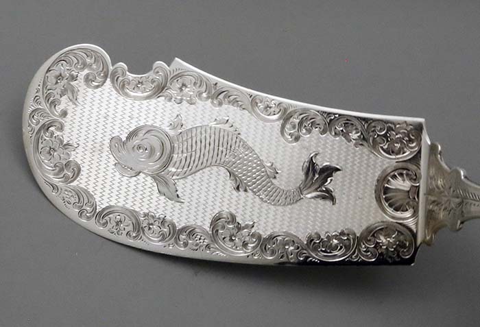 detail of engine turned blade with engraved fish